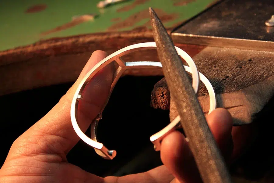 Filing and refining cast jewelry pieces by hand